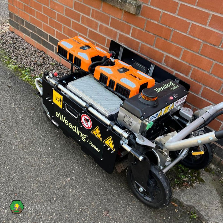 eWeeding roller killing weeds using electricity along the edge of a building